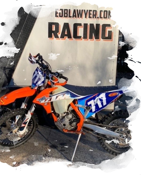 Dirtbike with EJ Boswell logo in background